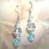 Triangular aqua beads enhanced with silver and Crystal Clear Acrylic Swirl beads.  Glowing with Silver earrings.