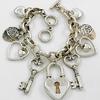 Burnished Silver Heart & Key Charm Bracelet with Toggle Closure.  Charms are up to 1 3/4" long.  (this is neither a biggish bracelet, nor is it tiny)
Lead Compliant Metal
