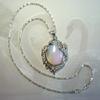 Beautiful Iridescent Moonstone set in Silver Designer Setting on 16" Snake Style Chain. 