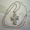 Silver Cross Enhanced with tear drop pearls and crystal rhinestones.  Chain is approximately 30" long with an extension.
Cross Pendant is 2 1/2" long by approximately 1 3/4" wide.