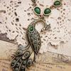Antique Peacock with enameled green "stones" Necklace. Approximately 17" long with an extension. Lobster clasp. Antiqued Peacock Pendant is approx. 2" long. Lead compliant 